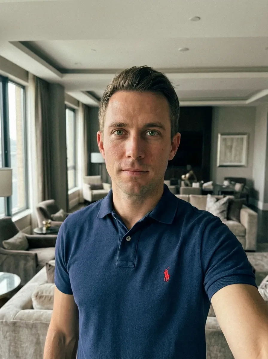 Original selfie input — man in a navy polo shirt indoors